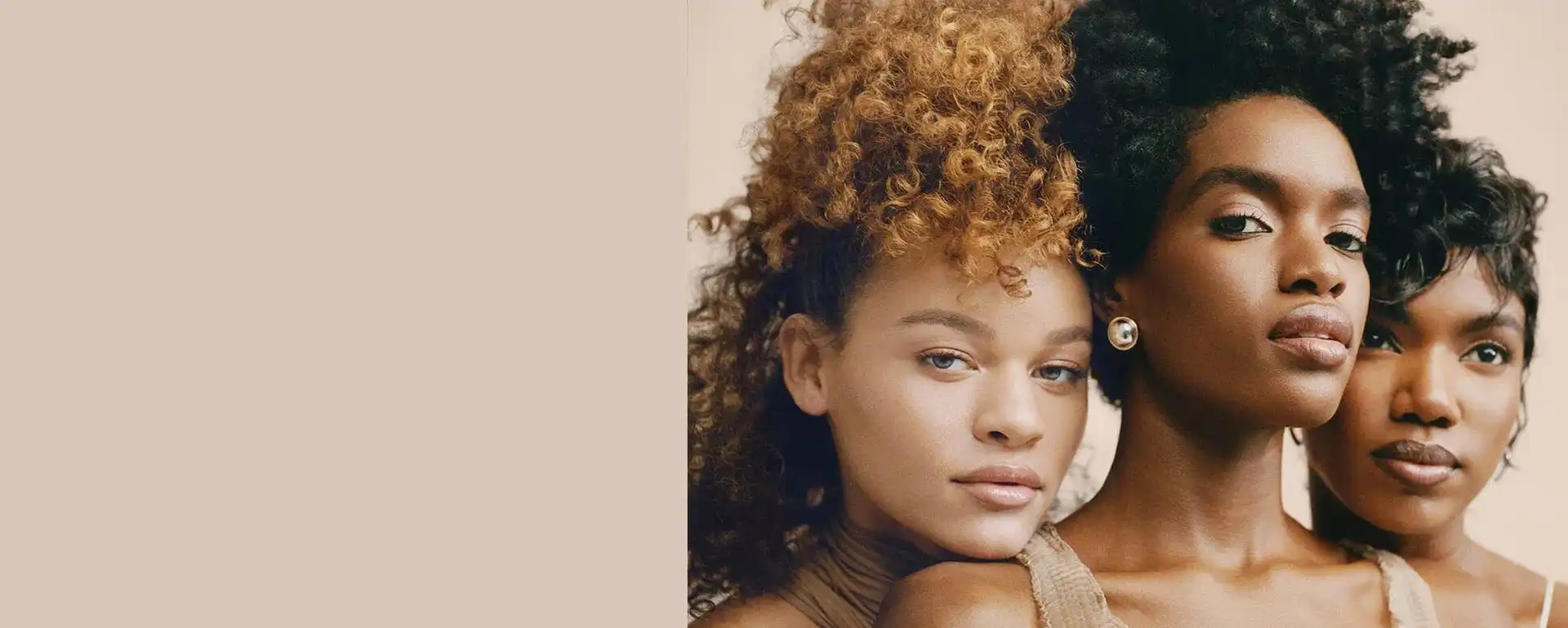 Three women with diverse hairstyles and makeup, posing elegantly against a neutral background.
